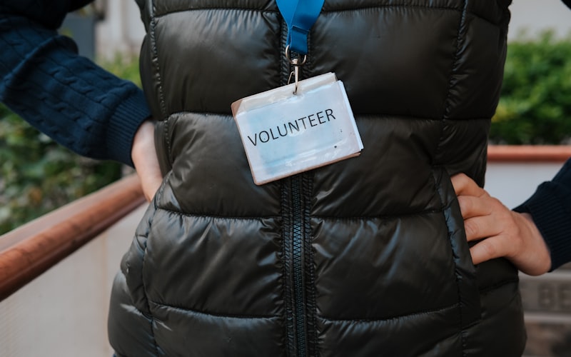 Volunteer with badge ready to help